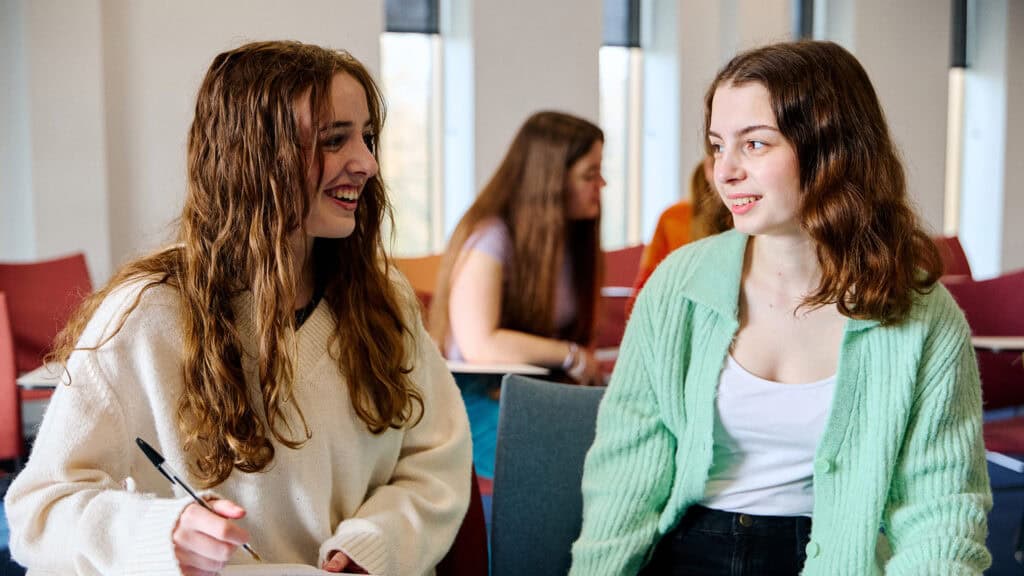 two students working together in the classroom