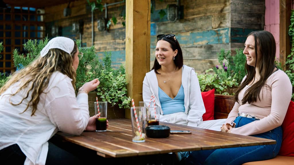 Students chatting in pub garden