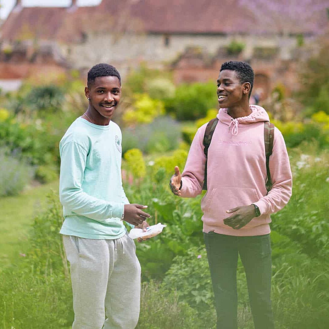 two students laughing in local park