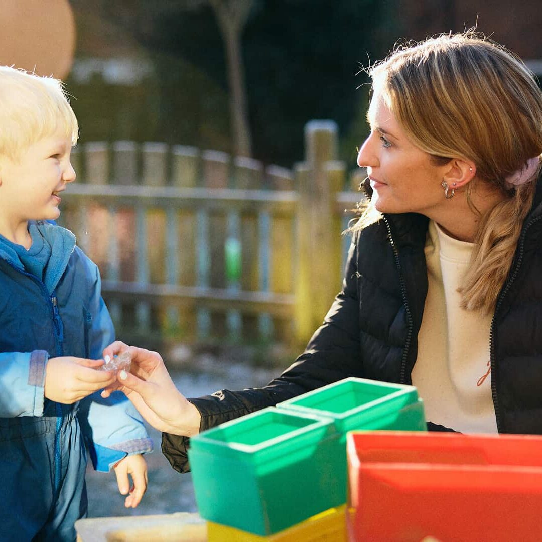 girl talking to child in playground