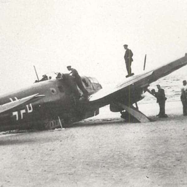 Plane on beach at the Witterings in black and white