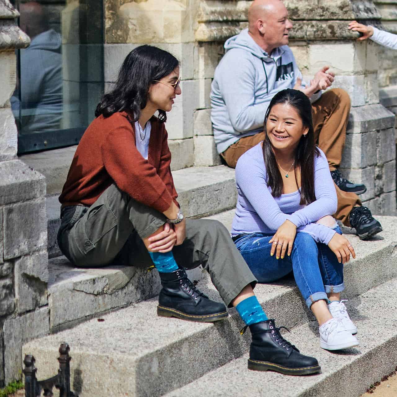 Students sat on steps outside Cloisters