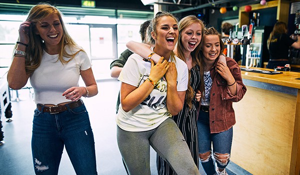 Students laughing at a bar
