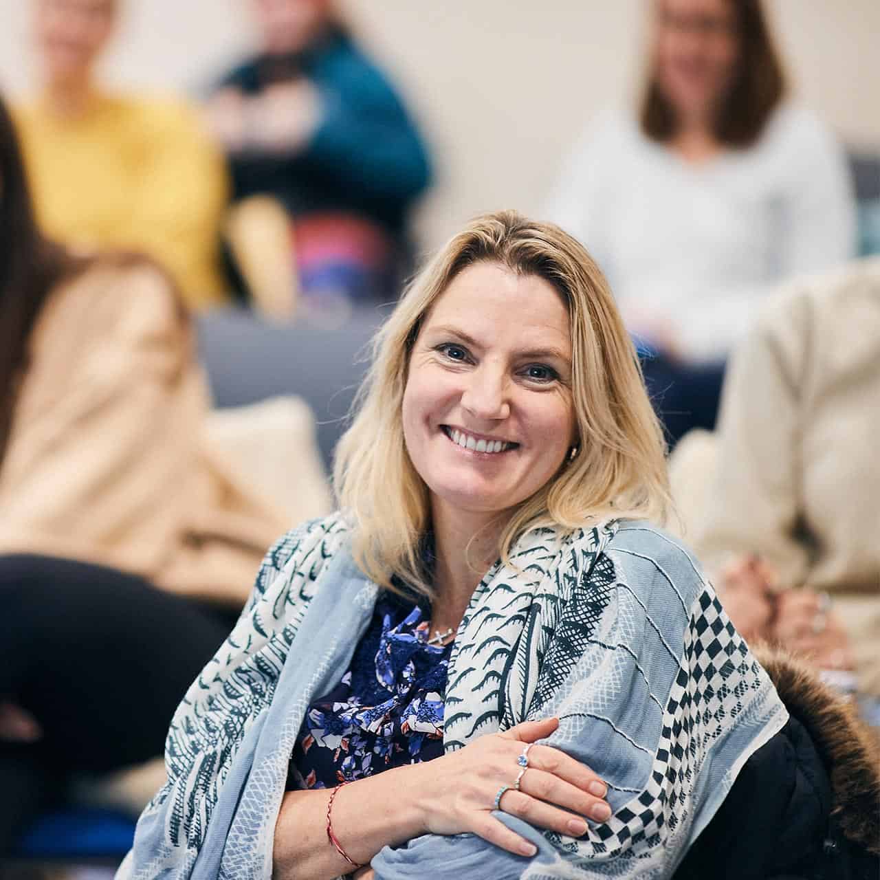 social work student sat in a lecture smiling