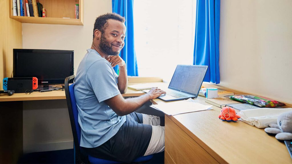 Student sitting at desk in accommodation