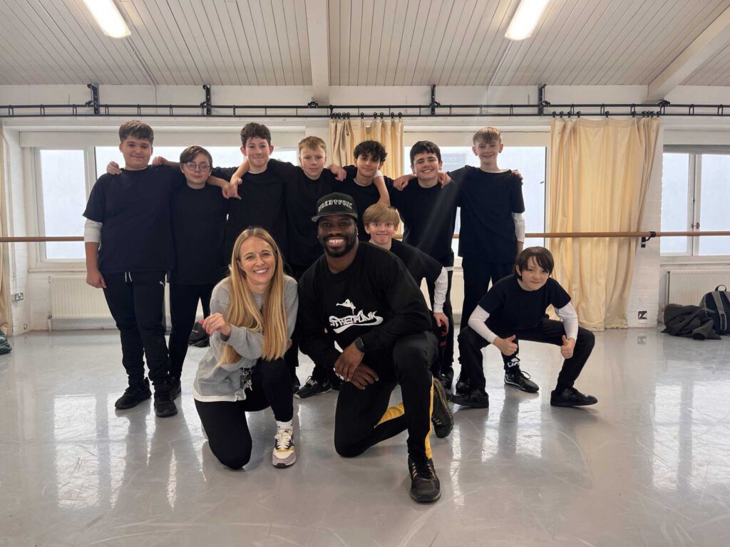 JP Omari with Alison Askew (Subject leader for Dance SRWA) and students from Sir Robert Woodard Academy