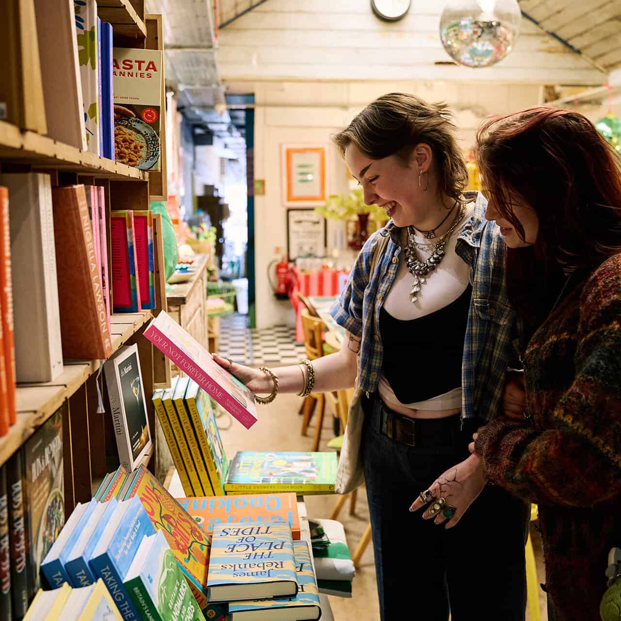 Two students browsing a book shop in Chichester town centre