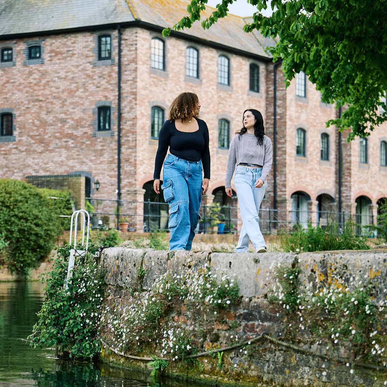 Two students walking by Chichester canal